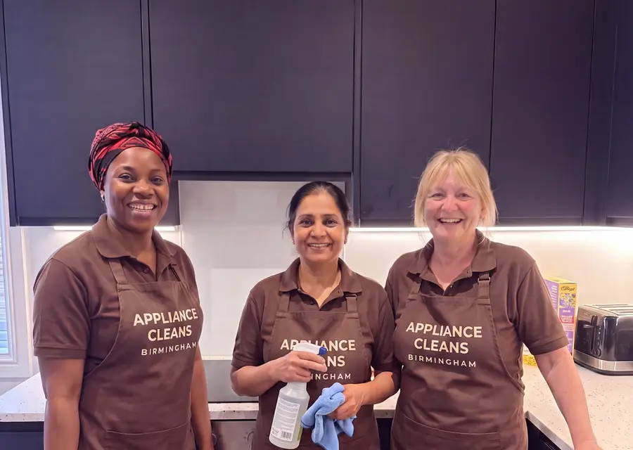 The Complete Cooker Cleanz team in a customer kitchen.